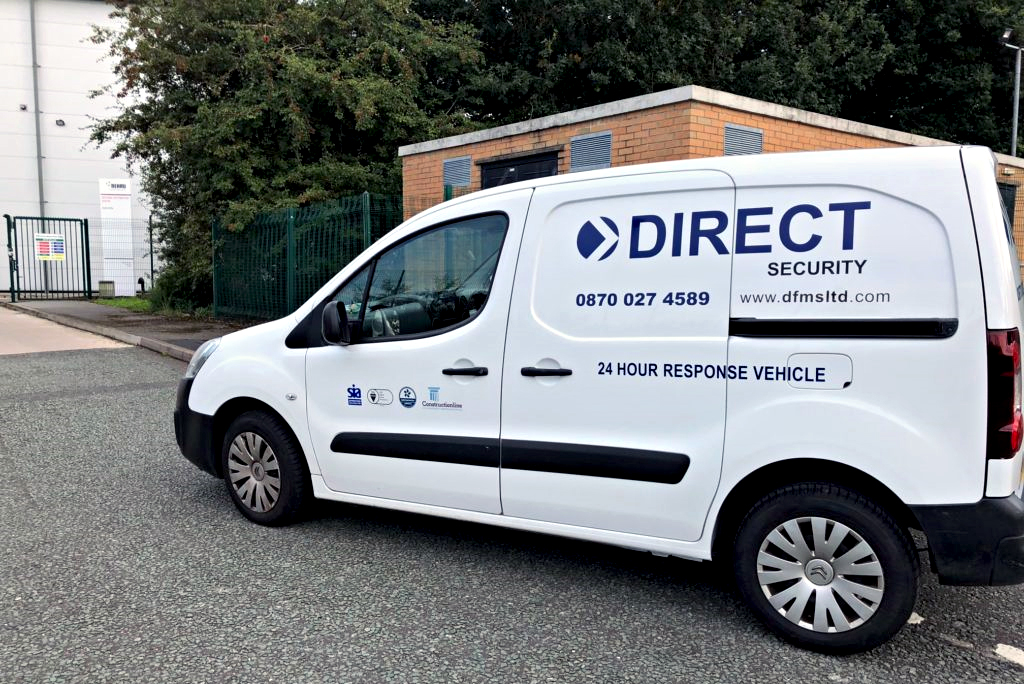White Belingo van with blue Direct Secuirty branding parked