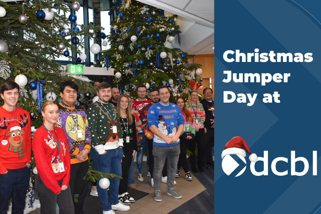 Staff in front of DCBL Christmas trees in Christmas jumpers